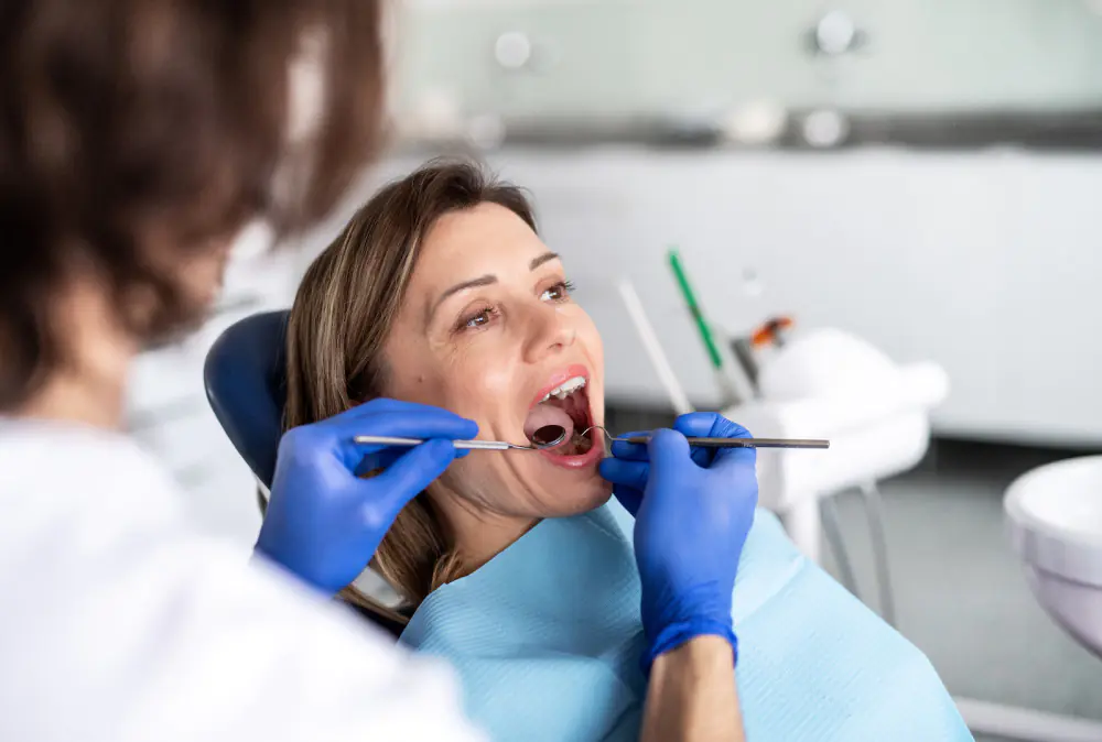 a woman has a dental check up in dentist surgery TUJTQXK